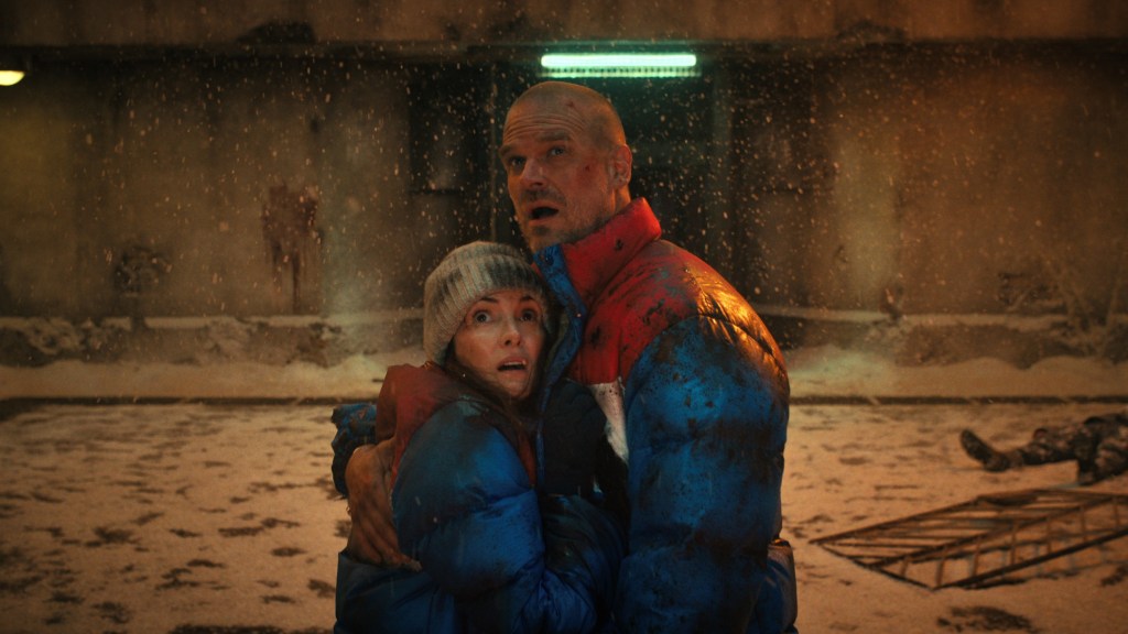 Joyce and Hopper hugging and looking up in Stranger Things Season 4