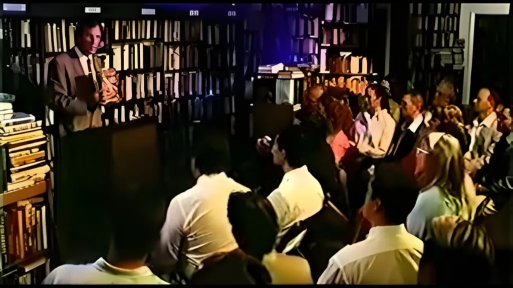 A con artist in front of a large audience in The Profit