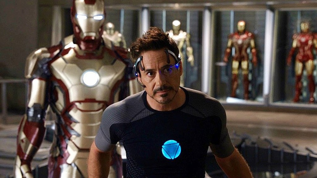 Tony Stark in front of his Iron Man suits in Iron Man 3