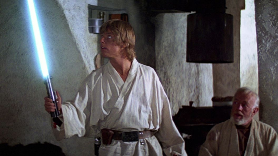 Luke wielding a lightsaber.