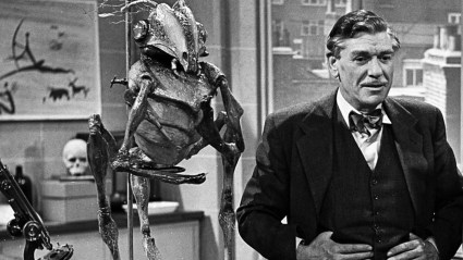 A creature lurking behind a scientist in Quatermass and the Pit (1958)
