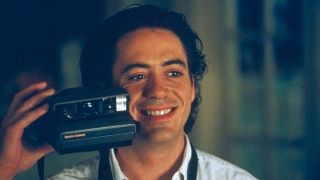 Robert Downey Jr. taking a photo in Home for the Holidays.