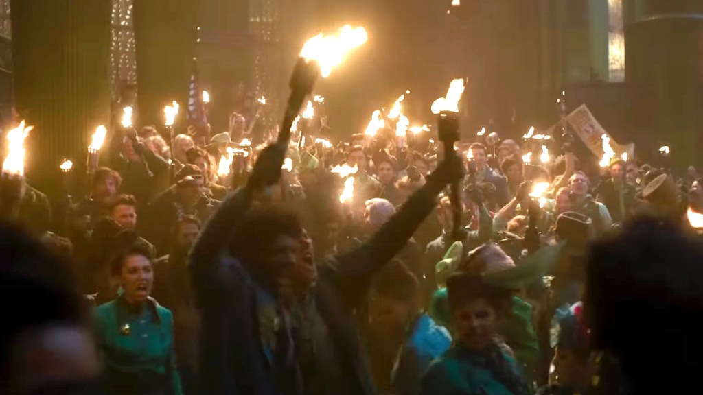 People marching with torches in Wicked: For Good