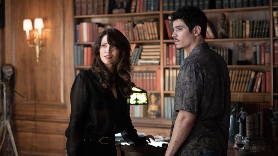 Two characters in a library in Witchboard.