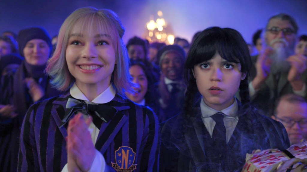 Enid smiling and Wednesday looking annoyed in Wednesday Season 2