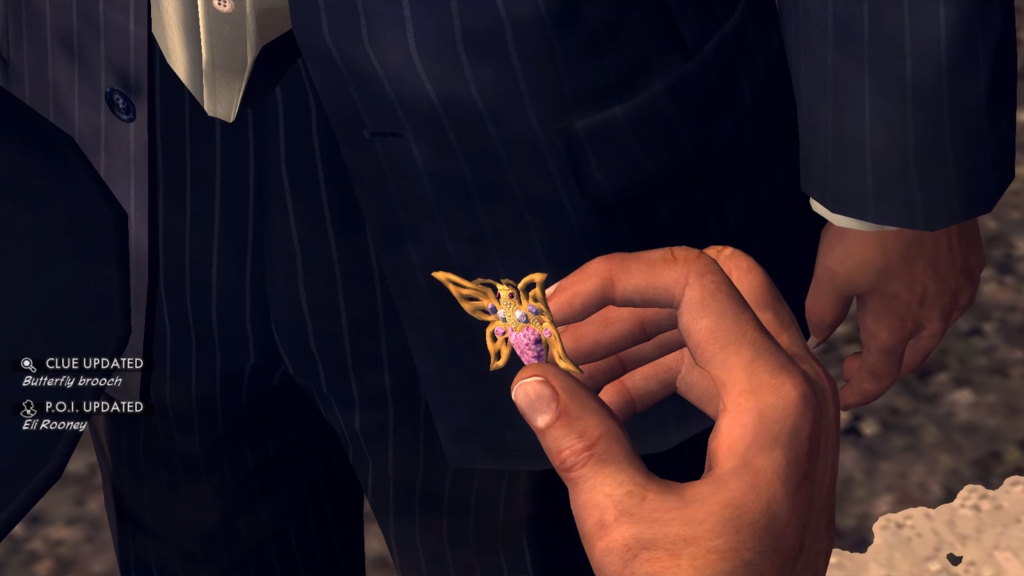 A screenshot from L.A. Noire, showing the player holding a golden butterfly clue.