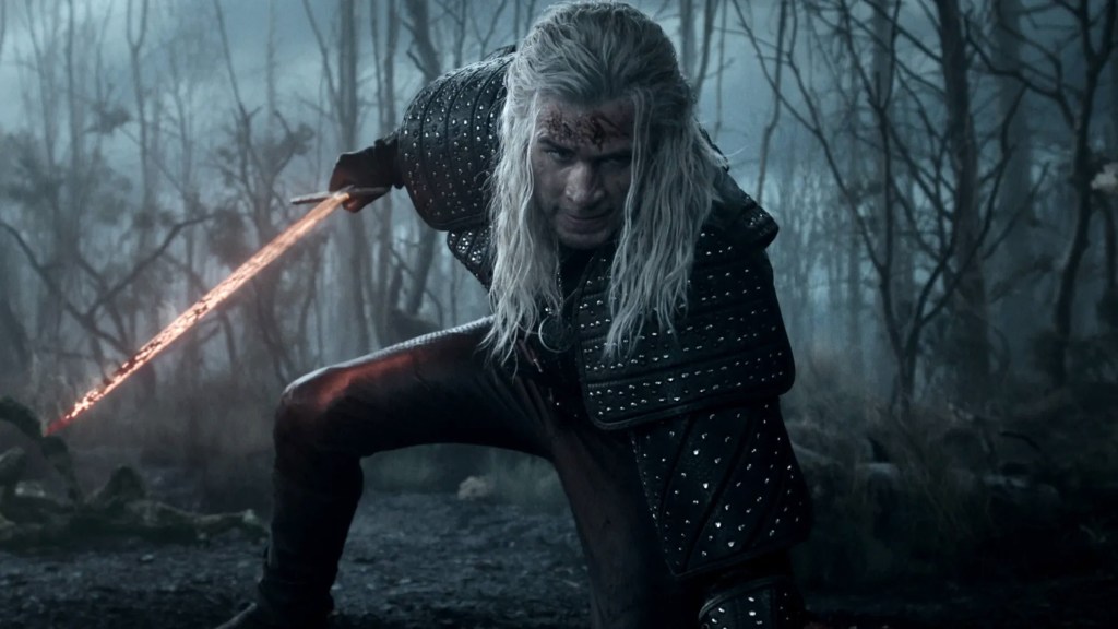 Liam Hemsworth as Geralt kneeling with his sword out in The Witcher Season 4