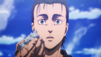 Eren holding out a shell and looking shocked in Attack on Titan