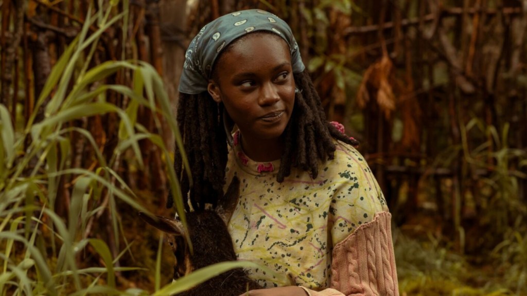 Akilah looking to the side and smiling in Yellowjackets