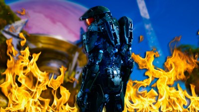 Master Chief looking sad in Halo 4 while surrounded by fire.