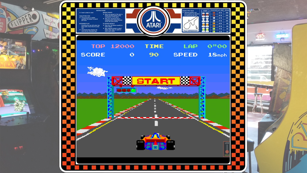 A screenshot from Pole Position with arcade art bezel over a picture of Retrovolt Arcade.