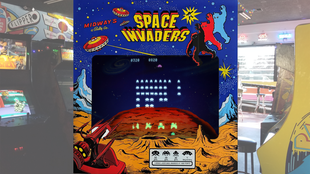 Space Invaders screen with arcade art bezel over a picture of Retrovolt Arcade.