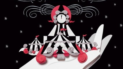 A hand holding circus tents on the cropped cover of The Night Circus
