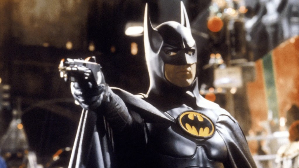 Michael Keaton as Batman aiming a gun in Batman (1989)