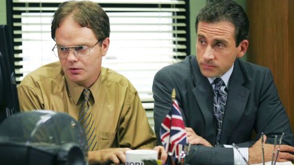 Dwight and Michael Scott in The Office sitting together at Michael's desk.