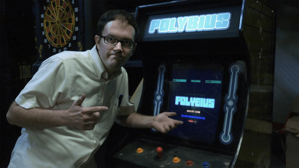The Angry Video Game Nerd showing off a full-size Polybius cabinet.