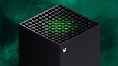 The top of an Xbox Series X against a green background.