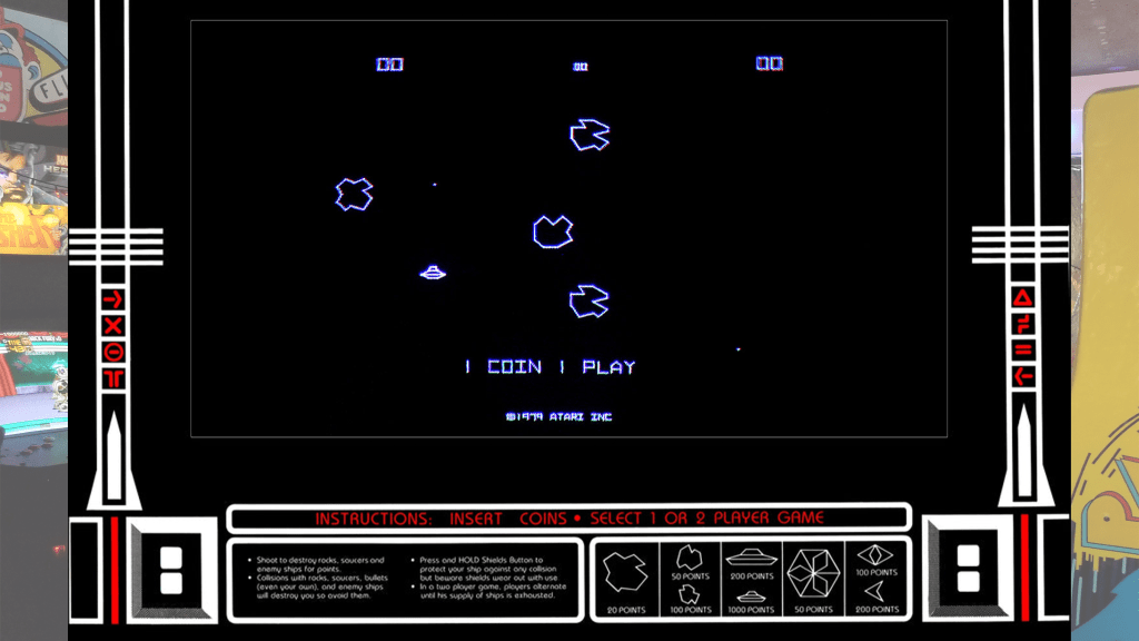 A screenshot from Asteroids with arcade bezel art over a picture of Retrovolt Arcade.