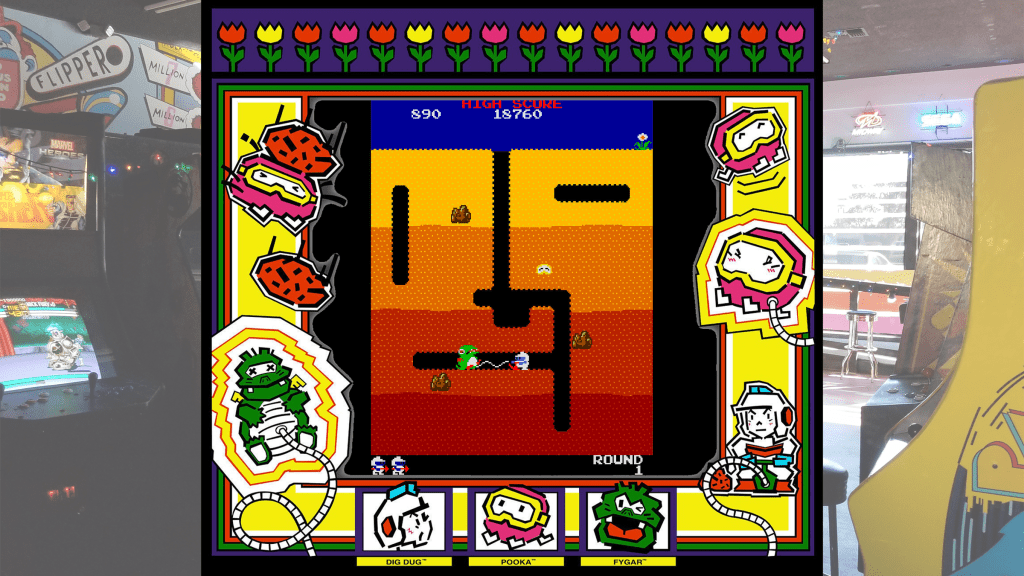 A screenshot from Dig Dug with arcade bezel art over a picture of Retrovolt Arcade.