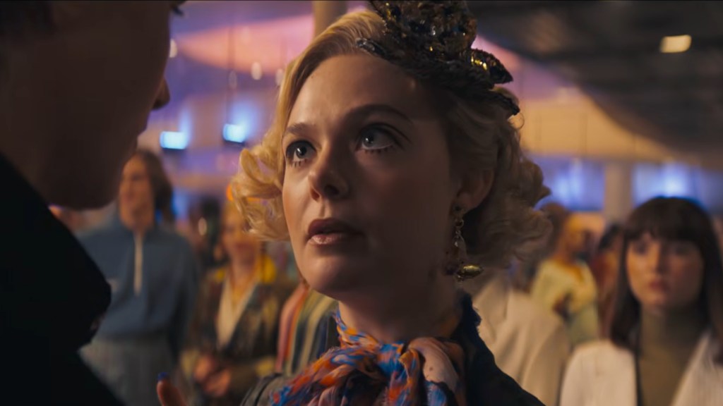 Elle Fanning as Effie Trinket looking up at someone in The Hunger Games: Sunrise on the Reaping