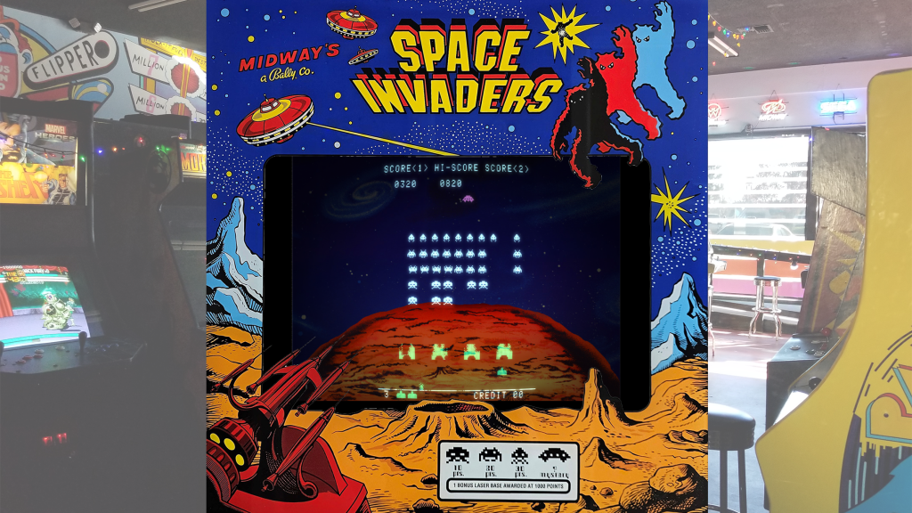 A screenshot from Space Invaders with arcade bezel art over a picture of Retrovolt Arcade.