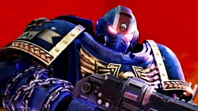 An Ultramarine from Warhammer 40,000: Space Marine 2 in front of the key art for Fire Warrior.