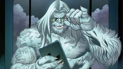 Beast as the Chairman holding a tablet and adjusting his glasses