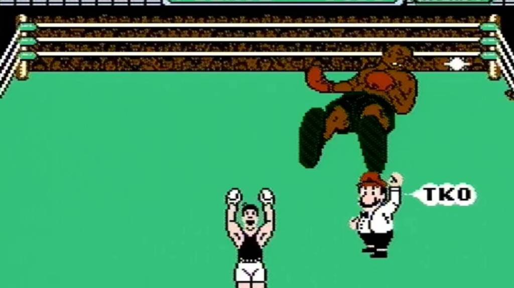 An image from Mike Tysonโs Punch-Out!! showing a knocked out Mike Tyson, the player celebrating, and the referee announcing a TKO.