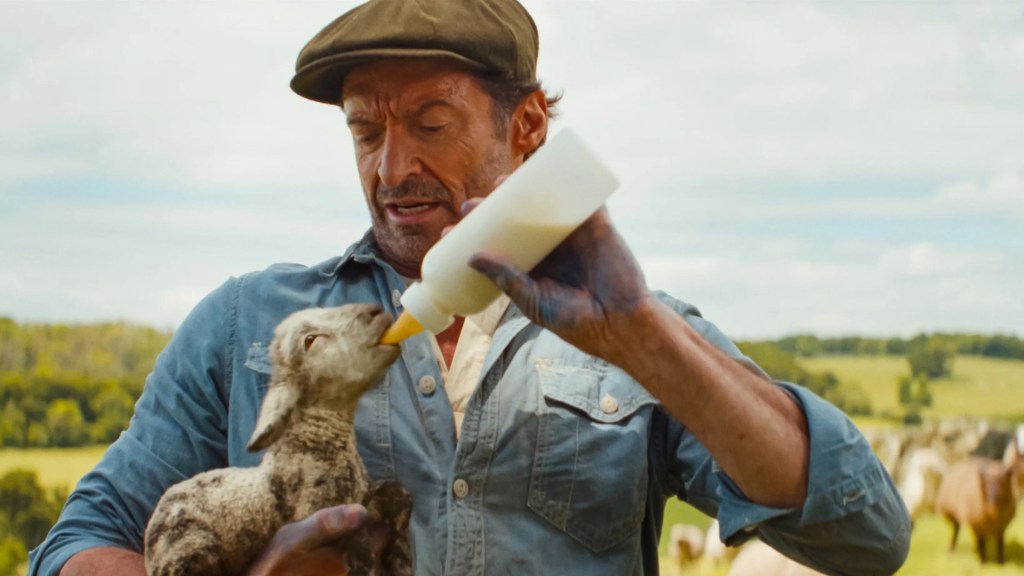 George feeding baby lamb in The Sheep Detectives