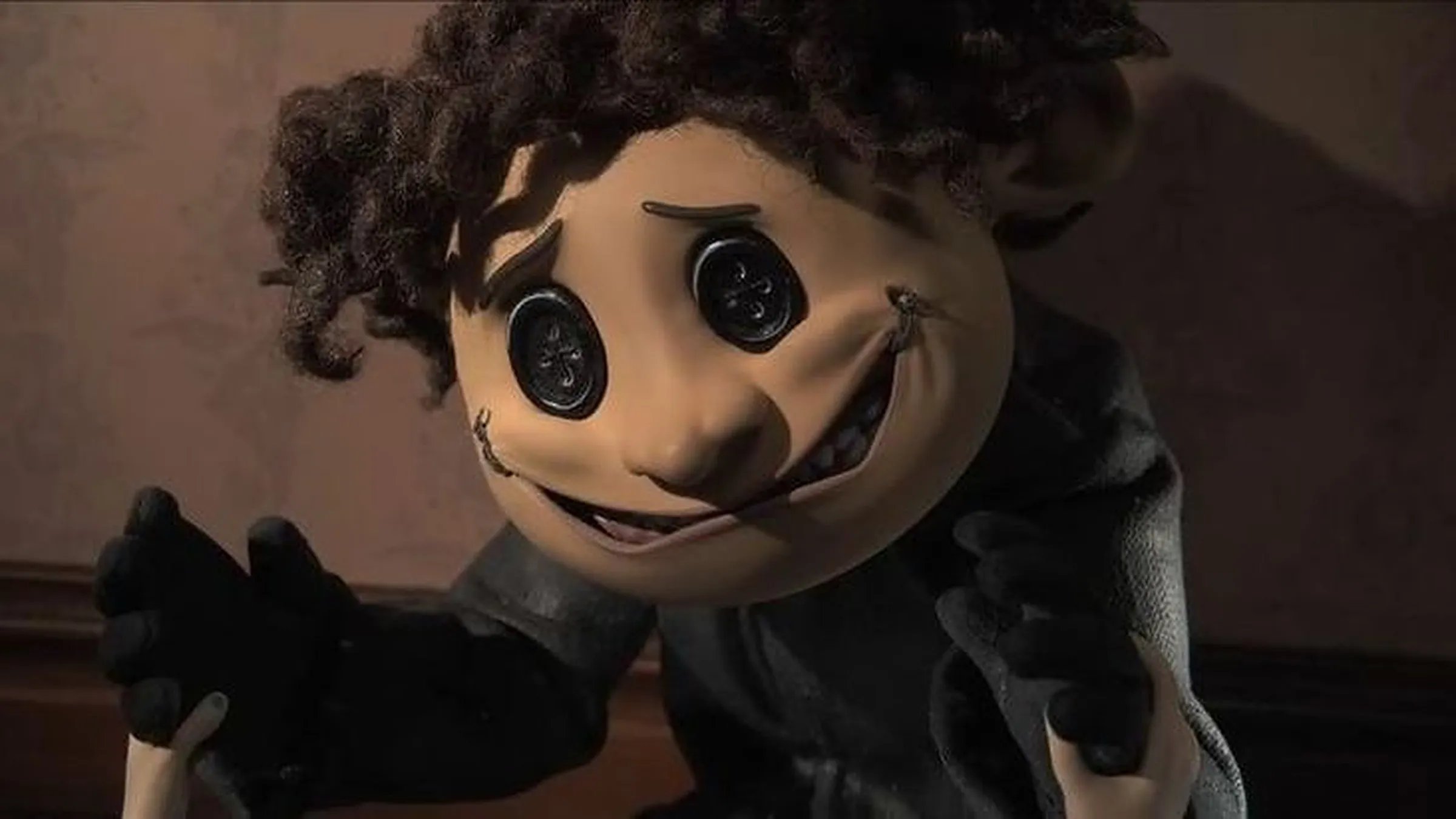 The Other Wybie with button eyes and a stitched smile in Coraline
