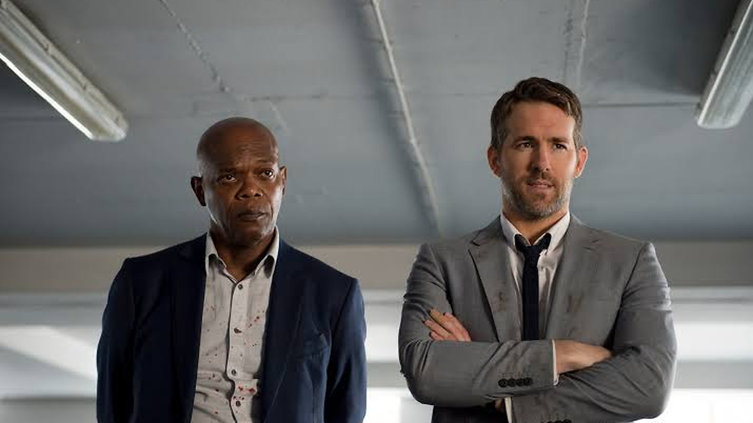 Samuel L. Jackson as Darius Kincaid and Ryan Reynolds as Michael Bryce in The Hitman’s Bodyguard.