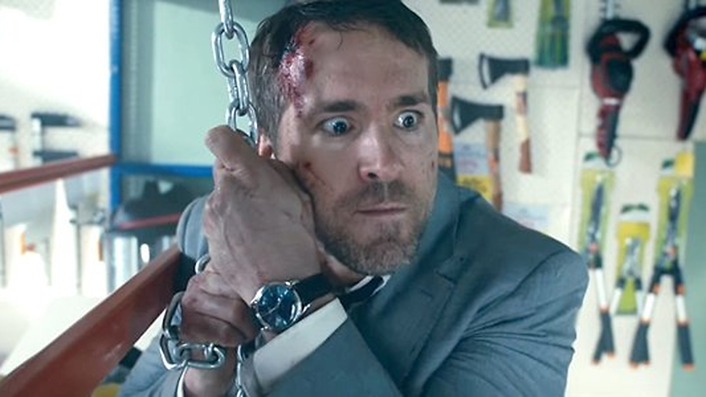 Ryan Reynolds as Michael Bryce, bloodied and chained, in The Hitman’s Bodyguard.