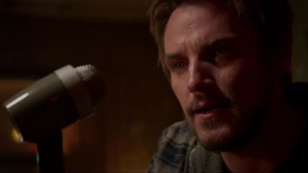 Frank Sullivan at a microphone in "Frequency."