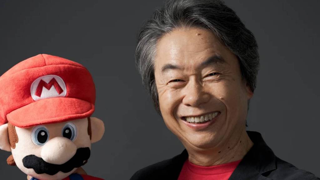 Shigeru Miyamoto with a Mario doll.