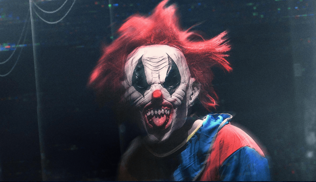 A disturbing clown looking at the camera with red hair.